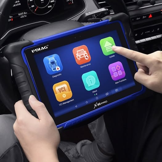 Mechanic using OBD2 scanner for computer diagnostic on a car